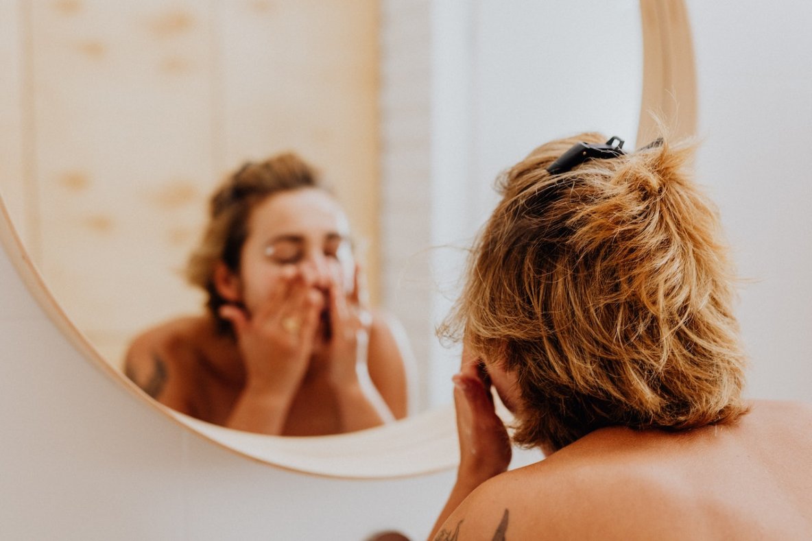 woman washing face in the bathroom